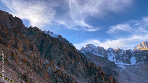 Fototapeta Naklejka Na Ścianę i Meble -  Harsh mountain landscape at dawn. Amazing view of rocks, ridges and snow-capped peaks. Ala Archa National Park in Kyrgyzstan.