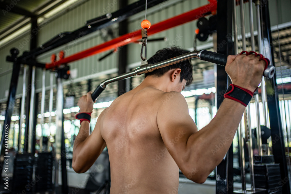 Man doing squat exercises with a barbell in gym Man doing squat exercises with a barbell in gym