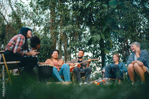 joy of outdoor BBQ parties. Capture unforgettable moments of family, friends, and delicious food amidst the warmth of campfires. Experience the ultimate gathering © chokniti