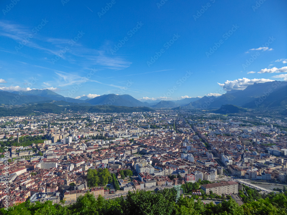 Aerial view of Grenoble old town seen from Bastille Fort, Auvergne-Rhone-Alpes region, France, Europe. View from above on the Isere Valley in the French Pre-Alps. Chartreuse Belledonne mountain range