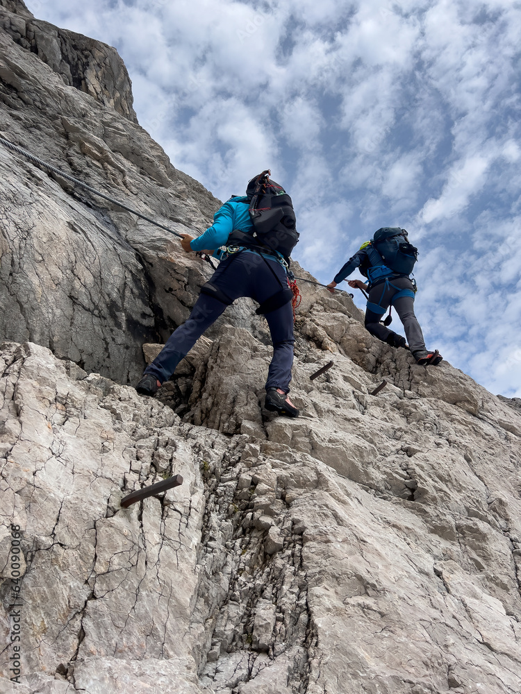 Hiker to Zugspitze by using the via ferrata hike trail path Hiker to Zugspitze by using the via ferrata hike trail path