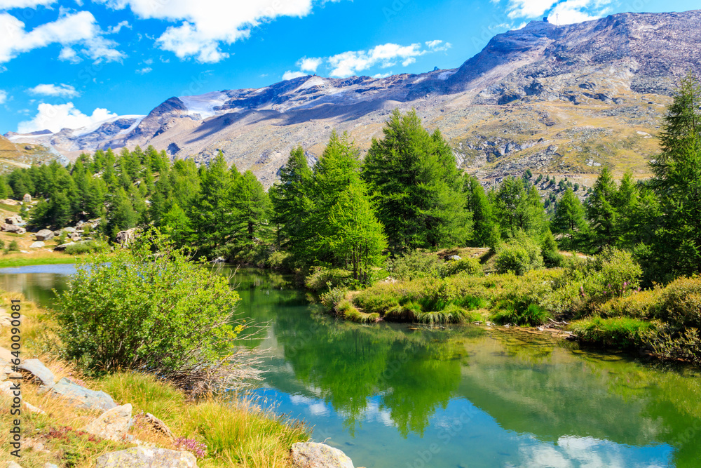 View of Grindji Lake (Grindjisee) and Swiss Alps at summer on Five-lake trail in Zermatt, Switzerland View of Grindji Lake (Grindjisee) and Swiss Alps at summer on Five-lake trail in Zermatt, Switzerland