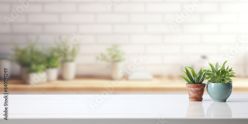 Empty white wooden tabletop with blurred white kitchen in the background. Mock up for display or montage of product