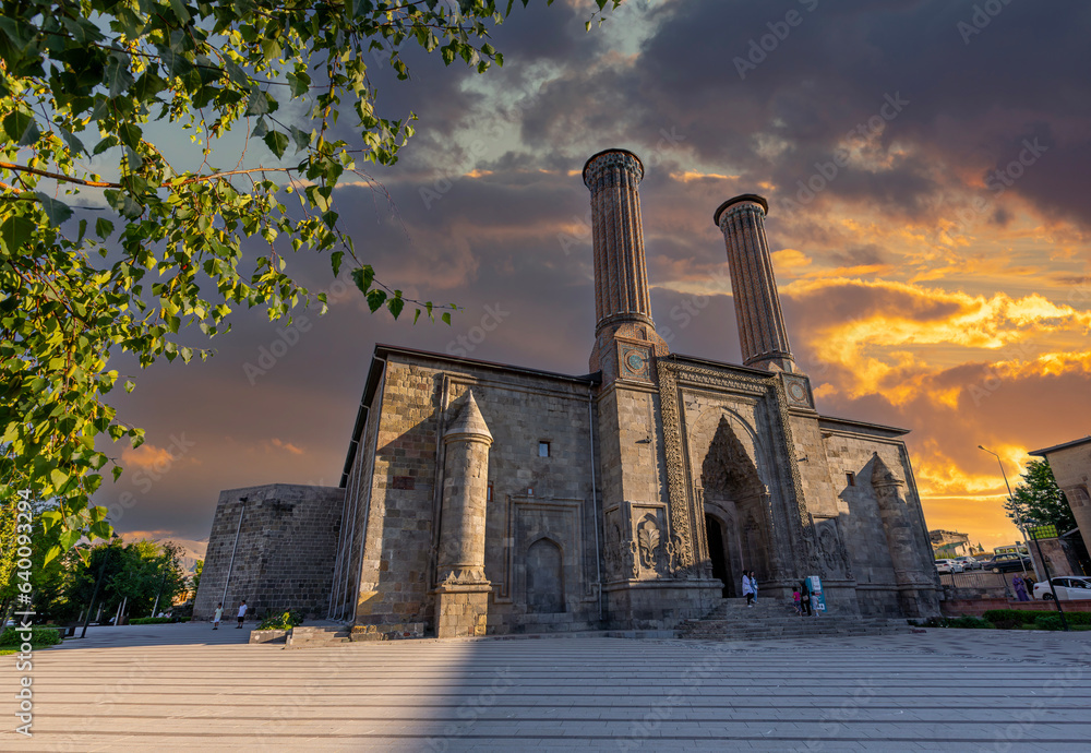 Naklejka premium Erzurum Double Minaret Madrasa, one of the Turkish historical buildings. Erzurum Double Minaret Madrasa at sunrise in summer. It is one of the most famous travel routes in Turkey. Erzurum, Turkey