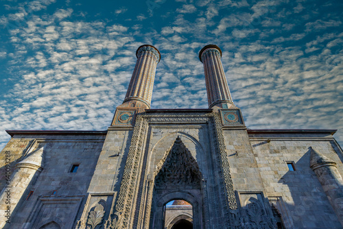 Erzurum Double Minaret Madrasa, one of the Turkish historical buildings. Erzurum Double Minaret Madrasa at sunrise in summer. It is one of the most famous travel routes in Turkey. Erzurum, Turkey photo