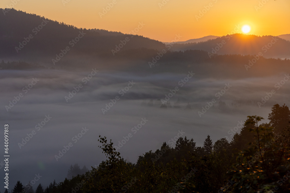 Sunrise with golden morning mist in a mountain valley, Croatia