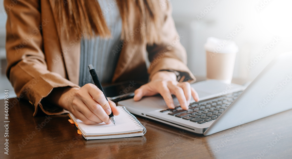 businesswoman hand working with new modern computer and writing on the notepad strategy diagram as concept businesswoman hand working with new modern computer and writing on the notepad strategy diagram as concept