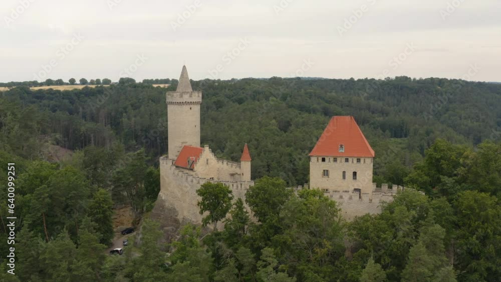 Medieval Kokorin castle in Czechia on hilltop above forest landscape. Medieval Kokorin castle in Czechia on hilltop above forest landscape.