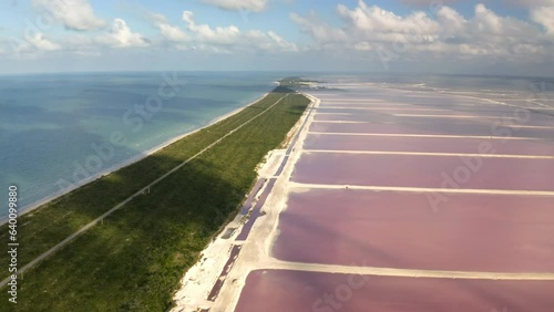 Salt ponds with pink water along coastal isthmus in Yucatan, Mexico.