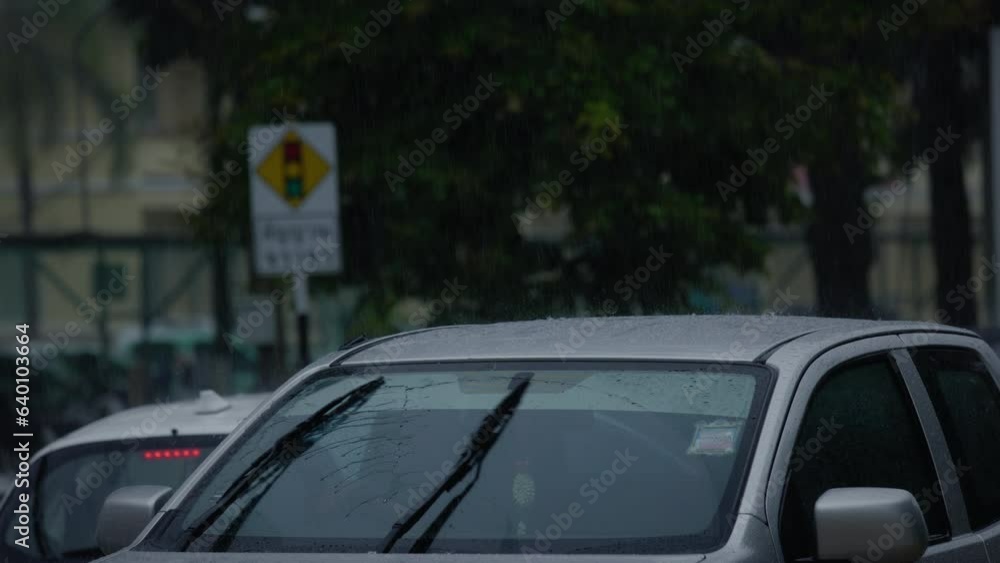 Driving a car in the city during a rainstorm. Driving a car in the city during a rainstorm.