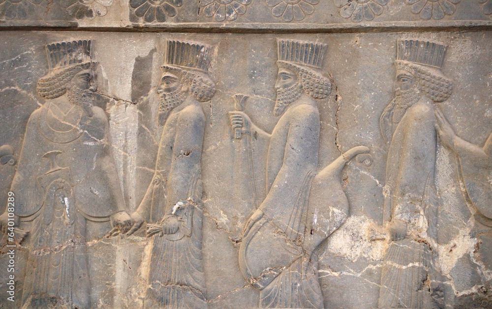 Ancient wall with bas-relief with assyrian foreign ambassadors with gifts and donations, Persepolis, Iran