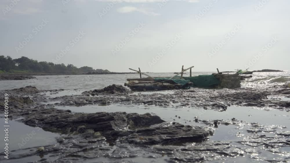 Fishing boats at shoreline with violent waves in India Fishing boats at shoreline with violent waves in India