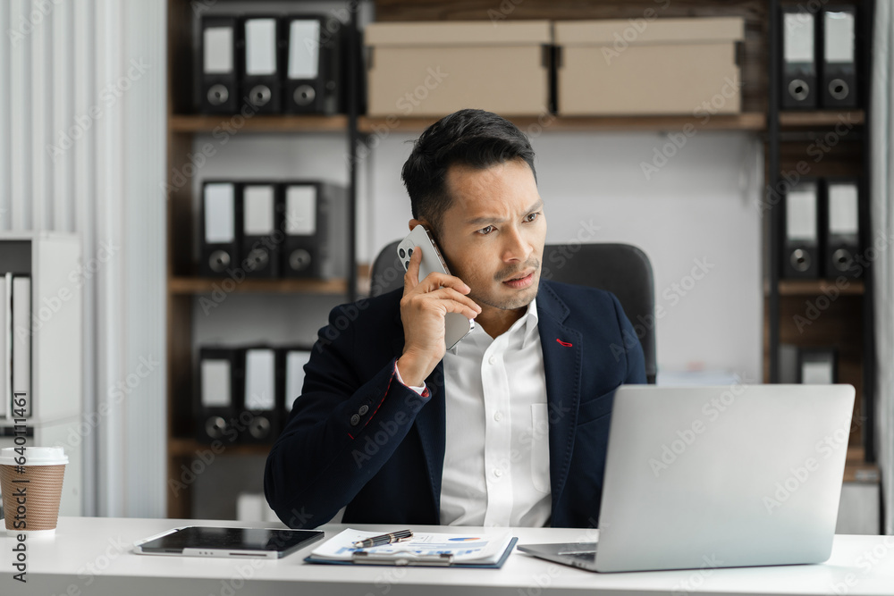 Male businessman talk mobile phones and working on laptop computers, online business, work from home, teleworking concept. Male businessman talk mobile phones and working on laptop computers, online business, work from home, teleworking concept.