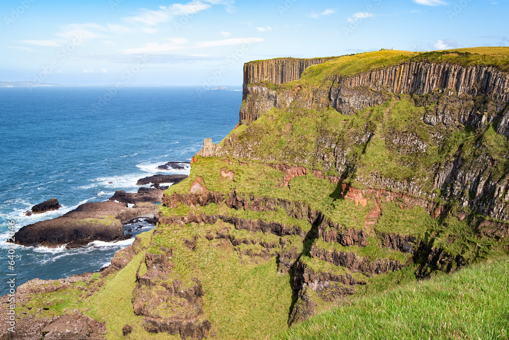 View to seaside basalt columns rocks at Causeway Coastal Way in Northern Ireland.