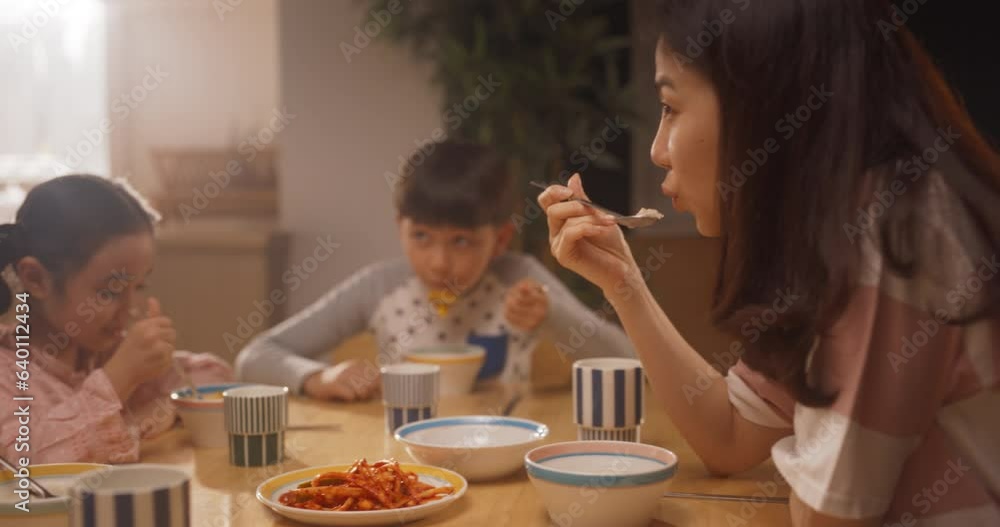 Portrait of Korean Family Having Breakfast or Lunch Together While Wearing Their Pyjamas. Young Parents and Their Adorable Cute Kids Having a Nutritious Healthy Meal to Start the Day with Energy Portrait of Korean Family Having Breakfast or Lunch Together While Wearing Their Pyjamas. Young Parents and Their Adorable Cute Kids Having a Nutritious Healthy Meal to Start the Day with Energy