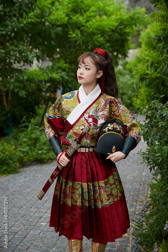 An Oriental beauty dressed in ancient warrior attire, wielding a weapon