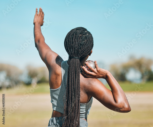 Woman, shot put and athlete throw in competition, challenge or training in field event with metal or steel weight. Throwing, ball or African female outdoor for athletics sport, game or strong contest photo
