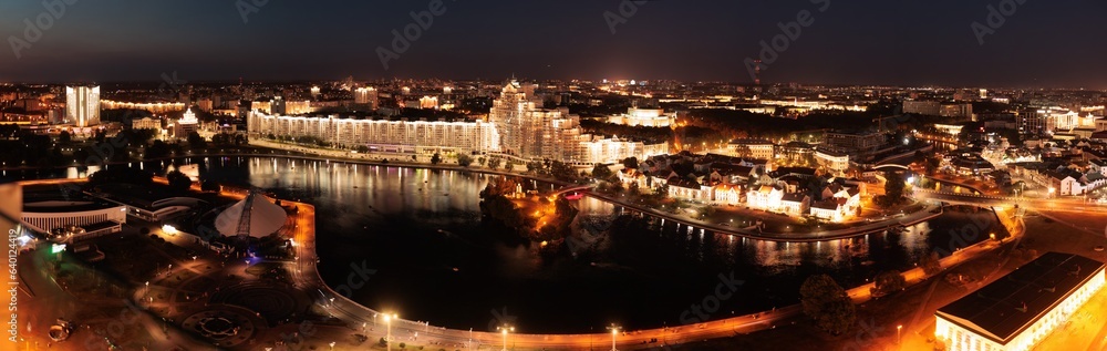 Top view of the night city, lights of lamps and cars in the dark