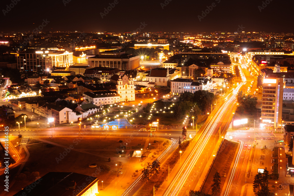 Top view of the night city, lights of lamps and cars in the dark