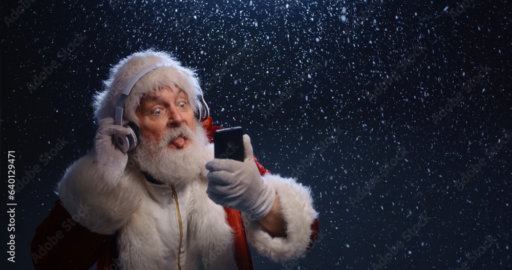 close up photo of shocked grey bearded santa claus use smartphone impressed xmas tradition season discounts headwear fly wear suspenders pants isolated blue color background close up photo of shocked grey bearded santa claus use smartphone impressed xmas tradition season discounts headwear fly wear suspenders pants isolated blue color background