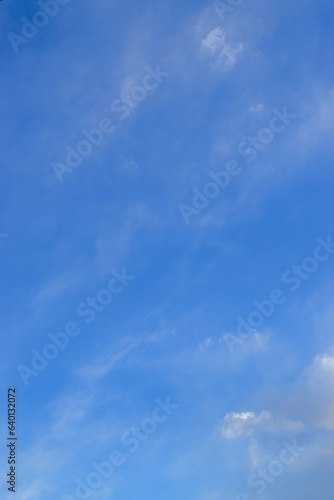 Peaceful blue sky with light clouds