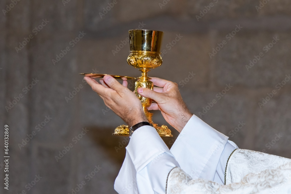 Catholicism Rituals Eucharist ceremony during mass. Catholic ritual. Priest in a white ...