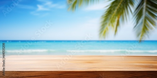 Wooden board on tropical beach. Sand and blue sky with palm leaf. Summer rest background with copy space