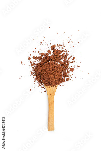 Cocoa powder pile on a wooden tea spoon, isolated on white background, flat lay soft focus