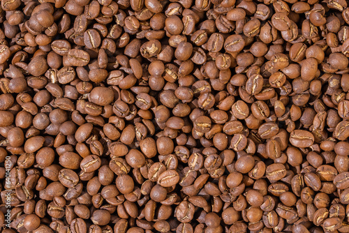 Roasted coffee beans top view wallpaper background.