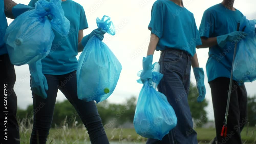 Side view Happy volunteer people group charity with garbage bags cleaning up in park. Corporate social responsibility and society activity for Environment . Ecology and CSR concept. Side view Happy volunteer people group charity with garbage bags cleaning up in park. Corporate social responsibility and society activity for Environment . Ecology and CSR concept.