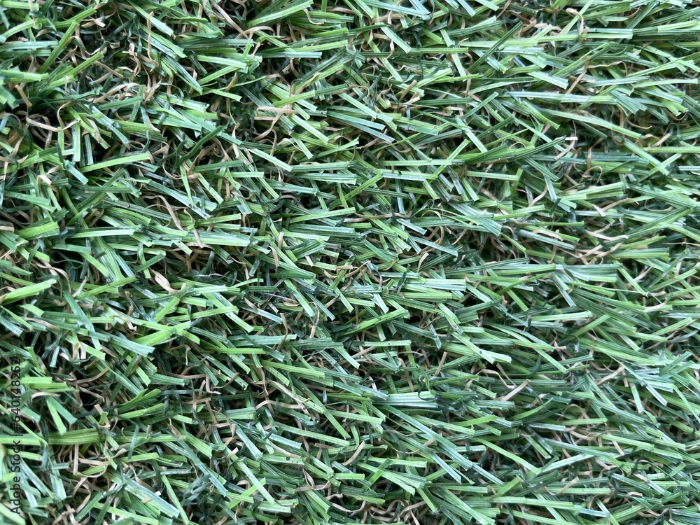 Green artificial grass background. Artificial turf stadium texture. Green artificial grass background. Artificial turf stadium texture.