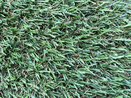 Green artificial grass background. Artificial turf stadium texture. 