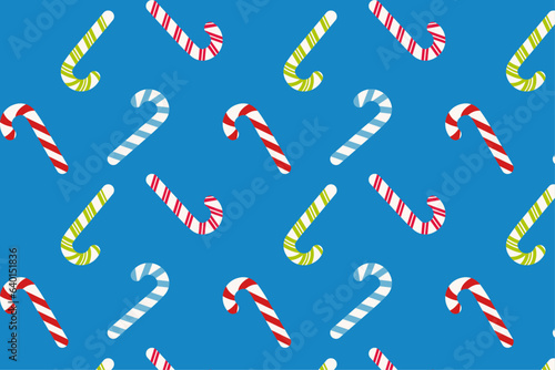 seamless pattern with New Year's candy canes on a blue background, vector pattern with candy sticks