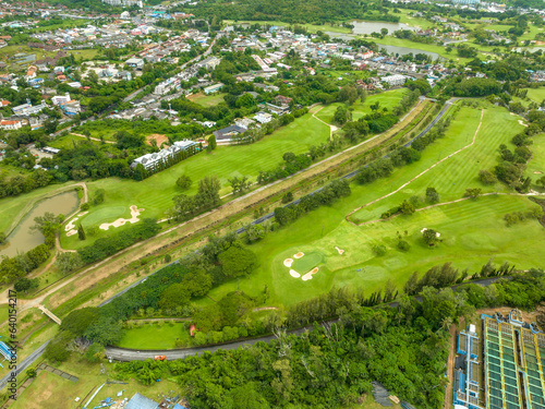 Aerial view drone shot of beautiful green golf field fairway and putting green,Top down image for sport background and travel background