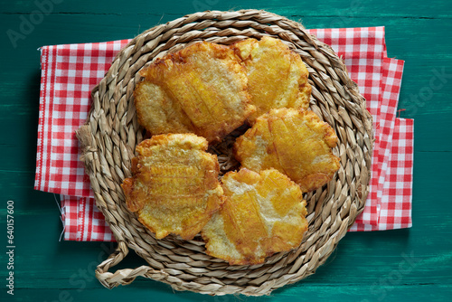 Patacones  also known as tostones  are thick pieces of fried green plantains. Colombian food.