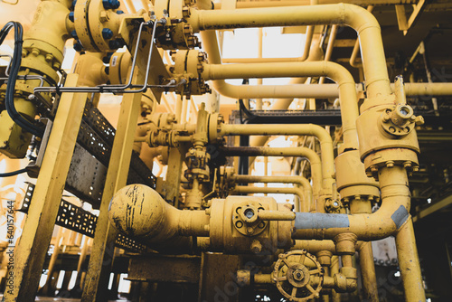 .Close-up of used flanges and welded pipes starting to rust with heavy metal fitting bolts on pipes that transport fluids to oil and gas rigs.