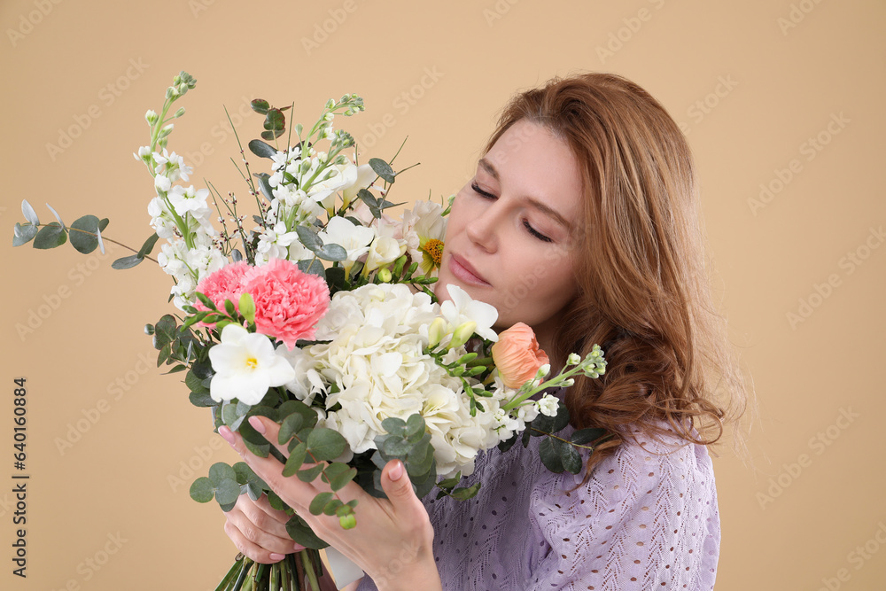 Beautiful woman with bouquet of flowers on beige background Beautiful woman with bouquet of flowers on beige background