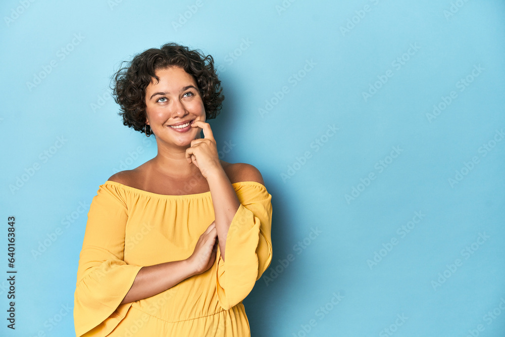 Young Caucasian woman with short hair relaxed thinking about something looking at a copy space. Young Caucasian woman with short hair relaxed thinking about something looking at a copy space.