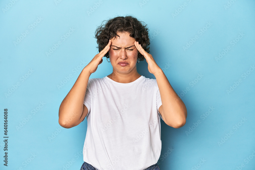 Young Caucasian woman with short hair touching temples and having headache. Young Caucasian woman with short hair touching temples and having headache.