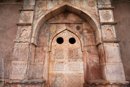 Carving details on the outer wall of the tomb of Roza of Khadija Bibi located in Mandu, Madhya Pradesh, India photo