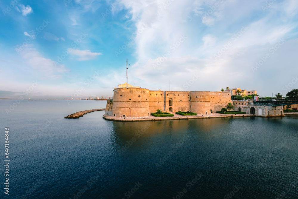 Taranto's Aragonese Castle by day, blue sky with clouds