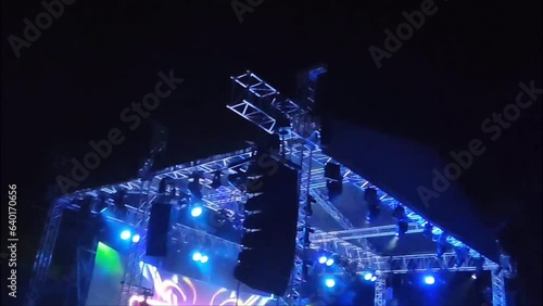 Special stage lighting equipment, various strobe lights with multicolored rays on the background of the dark night sky photo