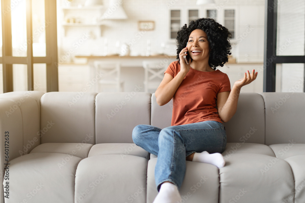 Making Call. Cheerful Young Black Woman Talking On Cellphone At Home Making Call. Cheerful Young Black Woman Talking On Cellphone At Home