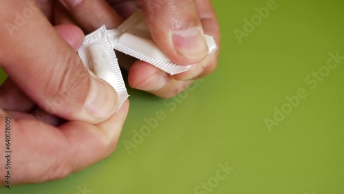 The package of the suppository for the treatment of hemorrhoids is opened. Prevention and treatment of hemorrhoids.