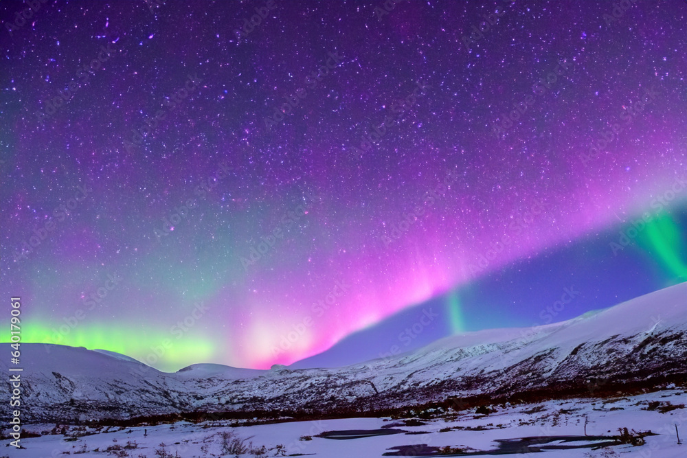 Northern Lights. Aurora. Iceland. Moment of greatest activity. Northern lights over the sea, snowy mountains. 2023. Northeast. Whitlebay. France. Italy. UK. Ukraine. Bulgaria. Ireland. Greece. USA.