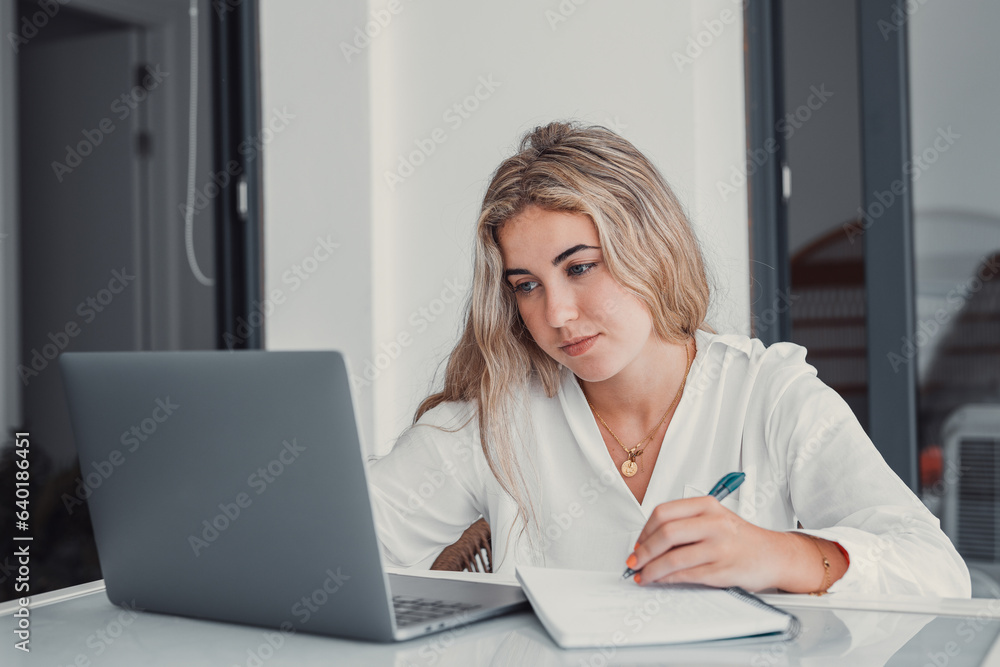 Head shot pleasant happy young woman freelancer studying on computer at home. Attractive businesswoman studying online, using laptop software, web surfing information or shopping in internet store.. Head shot pleasant happy young woman freelancer studying on computer at home. Attractive businesswoman studying online, using laptop software, web surfing information or shopping in internet store..