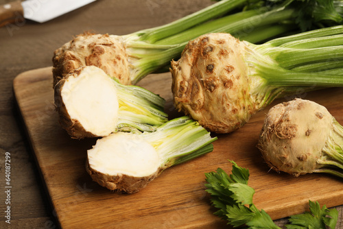 Fresh raw celery roots on wooden table, closeup