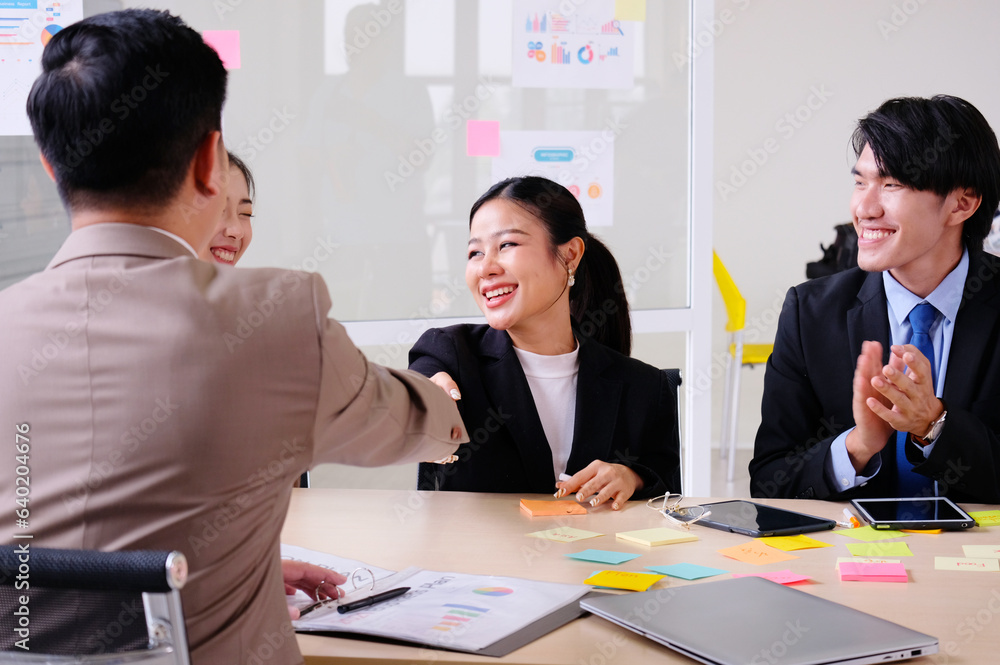 Businessmen smile, clap and shake hands during business meetings. Businessmen smile, clap and shake hands during business meetings.
