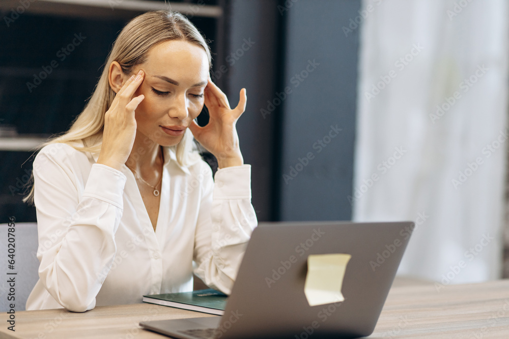 Woman working on laptop in building market with tiles Woman working on laptop in building market with tiles