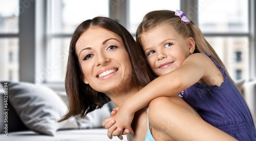 Happy young mom with teen child girl at home.